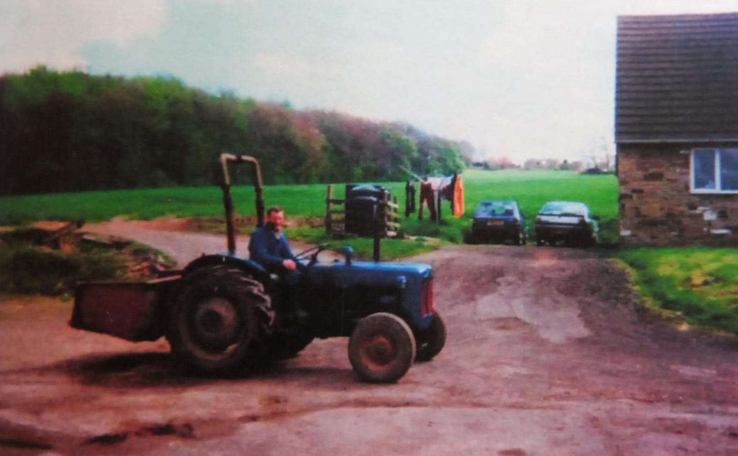 Photo of John Philip Charlesworth on his tractor at his farm.