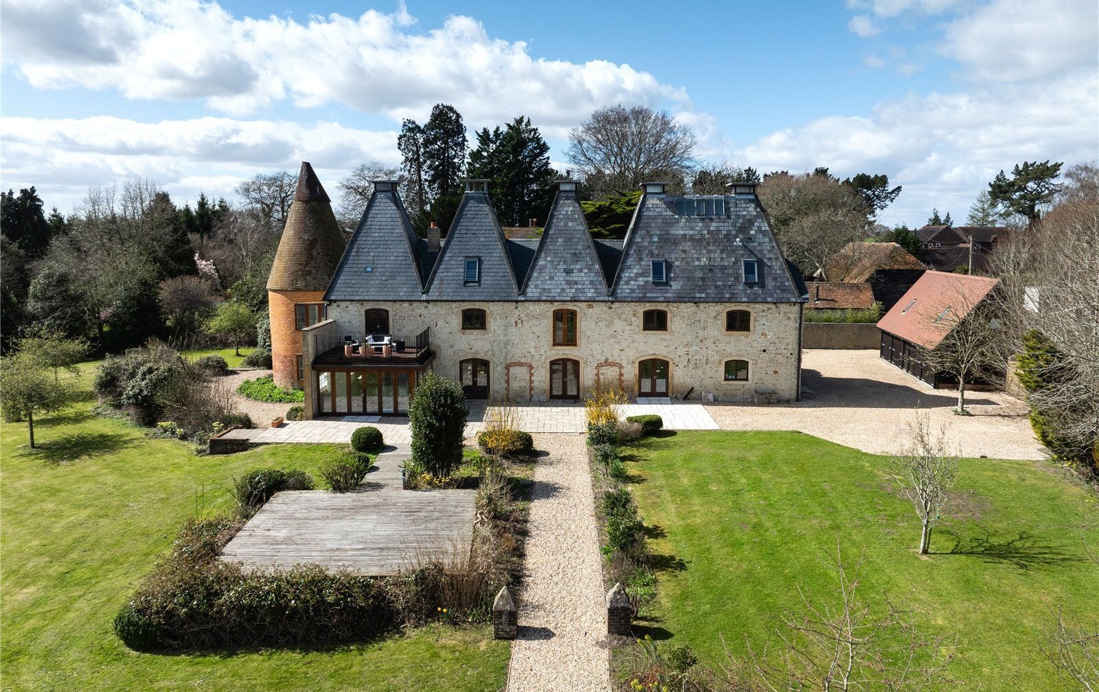 Aerial view of a converted oast house in the Hampshire countryside.